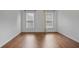 Spacious bedroom with hardwood floors and ample natural light from two large windows at 2983 Albright Nw Commons, Kennesaw, GA 30144