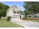 Charming home featuring a 2-car garage and a well-maintained front yard with mature landscaping at 2983 Albright Nw Commons, Kennesaw, GA 30144