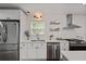 Bright kitchen with stainless steel appliances, white cabinets, quartz countertops, and open shelving at 2983 Albright Nw Commons, Kennesaw, GA 30144