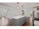 Spacious white kitchen with a gray kitchen island, hardwood floors, and modern lighting at 2983 Albright Nw Commons, Kennesaw, GA 30144