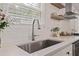 Modern kitchen sink with a stainless steel faucet, white quartz countertops, and a subway tile backsplash at 2983 Albright Nw Commons, Kennesaw, GA 30144