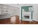 Open-concept living room with fireplace, hardwood floors, and a view into the modern kitchen and dining area at 2983 Albright Nw Commons, Kennesaw, GA 30144