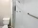 Modern bathroom featuring white tiled shower with glass doors and a standard toilet at 2992 Parc Lorraine, Lithonia, GA 30038