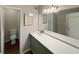 Bathroom vanity with modern countertops, sink, large mirror, and a toilet in the background at 2992 Parc Lorraine, Lithonia, GA 30038