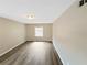 Neutral bedroom features wood-look floors and a window offering natural light at 2992 Parc Lorraine, Lithonia, GA 30038
