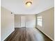 Bedroom with wood-look floors, a window providing light, and a white door at 2992 Parc Lorraine, Lithonia, GA 30038