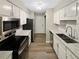 Modern kitchen features stainless steel appliances, white cabinets, and marble countertops at 2992 Parc Lorraine, Lithonia, GA 30038