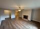 Spacious living room shows brick fireplace, ceiling fan and open floorplan with hardwood floors at 2992 Parc Lorraine, Lithonia, GA 30038
