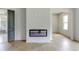 Cozy bedroom featuring a sleek fireplace, hardwood floors, and access to a bathroom at 3063 Reserve Ct Sw, Conyers, GA 30094