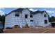 New home construction featuring a house wrapped in weather resistant material and ladders at 3063 Reserve Ct Sw, Conyers, GA 30094