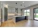 Modern kitchen features a large island, custom cabinets, and stainless steel appliances at 3063 Reserve Ct Sw, Conyers, GA 30094