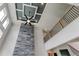Striking living room with custom ceiling, modern fan, and stone fireplace feature at 3063 Reserve Ct Sw, Conyers, GA 30094