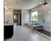 This luxurious main bathroom is equipped with dual vanities, a soaking tub, and a glass-enclosed shower at 3063 Reserve Ct Sw, Conyers, GA 30094