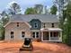 Stunning two-story brick home featuring a welcoming front porch and a beautifully designed roof at 3294 Mill Forest Dr, Conyers, GA 30094