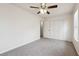 A spacious bedroom with neutral carpet, ceiling fan, natural light, and ample closet space at 4282 Worth Nw St, Acworth, GA 30101