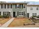 Townhouse exterior showcasing a well-kept lawn, sidewalk, and tidy landscaping at 4282 Worth Nw St, Acworth, GA 30101