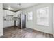 Bright kitchen features stainless steel appliances, white cabinets, and durable laminate flooring at 4282 Worth Nw St, Acworth, GA 30101