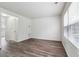 Bright living room with laminate flooring, large windows, and fresh white paint at 4282 Worth Nw St, Acworth, GA 30101