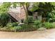 Backyard garden with hydrangeas and stone borders next to a brick home at 1508 Brianwood Rd # 1508, Decatur, GA 30033