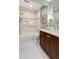 Bright bathroom with marble floors, a dark wood vanity, and a tiled shower-tub at 1508 Brianwood Rd # 1508, Decatur, GA 30033