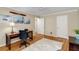Bedroom features a wooden desk, area rug, and pictures hanging on the wall at 1508 Brianwood Rd # 1508, Decatur, GA 30033