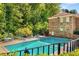 Inviting community pool with lounge chairs, surrounded by a fence and mature trees at 1508 Brianwood Rd # 1508, Decatur, GA 30033