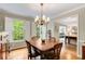 Traditional dining room featuring a classic chandelier, hardwood floors, and a view into an adjacent living space at 1508 Brianwood Rd # 1508, Decatur, GA 30033