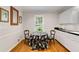 Bright kitchen nook with hardwood floors, a window view, and a charming table setting adjacent to sleek white cabinets at 1508 Brianwood Rd # 1508, Decatur, GA 30033