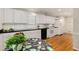 Modern kitchen with sleek white cabinets, dark countertops, stainless steel appliances, and hardwood floors at 1508 Brianwood Rd # 1508, Decatur, GA 30033