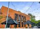 Unique orange-colored restaurant exterior with string lights and awning at 1508 Brianwood Rd # 1508, Decatur, GA 30033