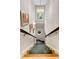 Grand staircase with a decorative carpet runner, chandelier, and charming windows at 1508 Brianwood Rd # 1508, Decatur, GA 30033