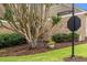 Street view of a bench by street sign, with lush greenery and brick wall at 1508 Brianwood Rd # 1508, Decatur, GA 30033