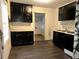 Compact kitchen featuring ample cabinet space, stainless steel sink, and a sleek black backsplash at 1846 North Ave, Atlanta, GA 30318
