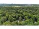 An aerial view captures a house nestled among dense trees, offering a sense of privacy and seclusion at 229 Devonwood Dr, Atlanta, GA 30328