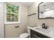 Modern bathroom features a sleek vanity, black fixtures, and a glass-enclosed shower at 229 Devonwood Dr, Atlanta, GA 30328