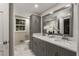 Bathroom with double vanity, marble countertops, and modern fixtures at 229 Devonwood Dr, Atlanta, GA 30328