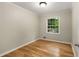 Cozy bedroom with hardwood floors and window view of mature trees at 229 Devonwood Dr, Atlanta, GA 30328