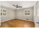 Bedroom with hardwood floors, plantation shutters, and modern ceiling fan at 229 Devonwood Dr, Atlanta, GA 30328