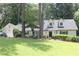 Charming one-story home with dormer windows, a well-manicured lawn, and mature trees at 229 Devonwood Dr, Atlanta, GA 30328