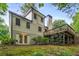 A two-story home features a combination of siding and brickwork, complemented by a well-maintained lawn and mature trees at 229 Devonwood Dr, Atlanta, GA 30328
