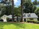 Charming single-story home featuring well-maintained landscaping, a spacious lawn, and attached two-car garage at 229 Devonwood Dr, Atlanta, GA 30328