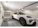 Clean garage featuring a new white car being charged at 229 Devonwood Dr, Atlanta, GA 30328