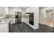 Modern kitchen with granite countertops, stainless steel appliances, and gray tone flooring at 229 Devonwood Dr, Atlanta, GA 30328
