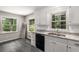 Charming kitchen with granite countertops, white cabinets, and new flooring at 229 Devonwood Dr, Atlanta, GA 30328