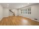 Open living room with hardwood floors, recessed lighting, and staircase access at 229 Devonwood Dr, Atlanta, GA 30328
