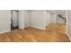 Spacious room with hardwood floors, and views to the kitchen and staircase at 229 Devonwood Dr, Atlanta, GA 30328