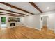 Spacious living room with hardwood floors, exposed beam ceiling, and cozy brick fireplace at 229 Devonwood Dr, Atlanta, GA 30328