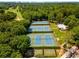An aerial view showcases multiple meticulously maintained tennis courts surrounded by lush greenery, offering a recreational space at 229 Devonwood Dr, Atlanta, GA 30328