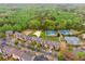 An aerial view of the community amenities: tennis courts, pond, and volleyball court at 2539 Larson Creek Cv, Duluth, GA 30097
