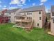 Aerial view of a backyard featuring a deck, stairs, patio, and lush green lawn at 2539 Larson Creek Cv, Duluth, GA 30097